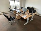 un bureau avec deux ordinateurs et une chaise dans une pièce