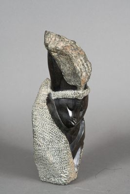 statue of a woman with a hat on her head and a scarf around her neck