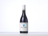 a bottle of red wine sitting on top of a table