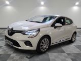 a white car is parked in a room with a checkered floor