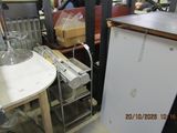 an image of a kitchen with a refrigerator and a table
