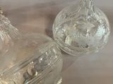 two clear glass vases sitting on a table