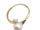 a close up of a pearl ring on a white background