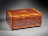an antique wooden box with a decorative decoration on the lid