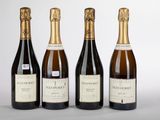 trois bouteilles de vin posées l'une à côté de l'autre sur une table