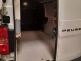 a white van with the door open in a garage