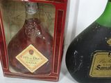 two bottles of liquor sitting next to each other on a table