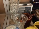 a table that has a bunch of cups and a vase on it