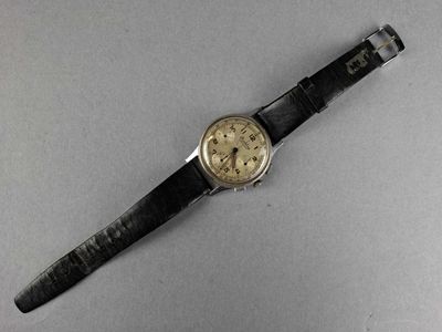 a close up of a watch on a table with a white background