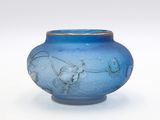 a blue glass vase with a horse drawn on it