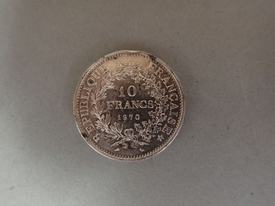 a silver coin with a picture of france on it