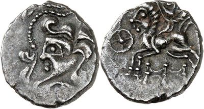 a silver coin with an image of a horse on it