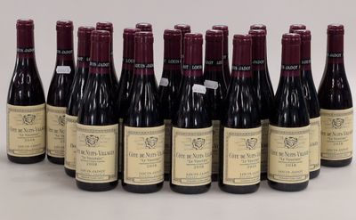 six bottles of wine are lined up in a row on a white surface