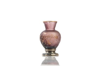 a pink glass vase sitting on top of a table