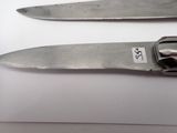 two knives that are sitting next to each other on a table