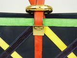 a colorful purse with a gold ring on top of it
