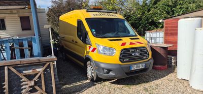 a yellow van that is parked next to a house