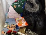 a pile of clothes and other items in a trash can