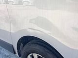 a white van that is parked on the side of the road