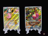two pokemon cards on display on a black background