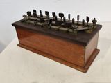 an old wooden box with a bunch of keys on top of it