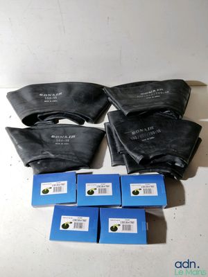 four bags of blue and black ink sitting on top of a white table