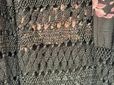 a close up of a black dress with pink flowers on it