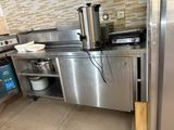 a stainless steel kitchen with a stove and a dishwasher on the counter