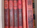 many books in a box that are sitting on the floor