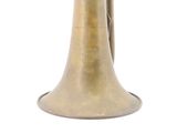 a brass bell that is sitting on a white surface