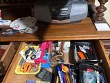 a desk with a drawer full of office supplies