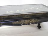 a black table with a glass top on a white background