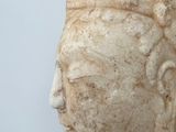 a stone statue of a woman with a head of hair