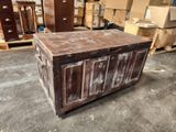 a large wooden chest sitting in a warehouse with many boxes