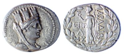 a close up of two silver coins on a white surface