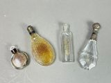 three bottles of perfume and a bottle of perfume on a table