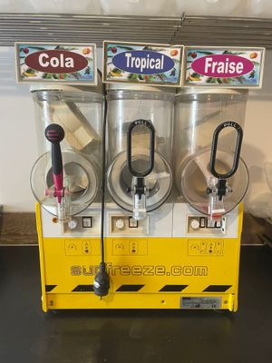 three soda dispensers sitting on a counter top