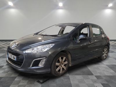 the grey car is parked on a checkered floor in the garage
