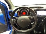 the interior of a small car with a steering wheel and dashboard