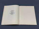 an open book on a table with a blue background