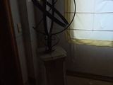 a statue of a sundialer sitting in front of a window