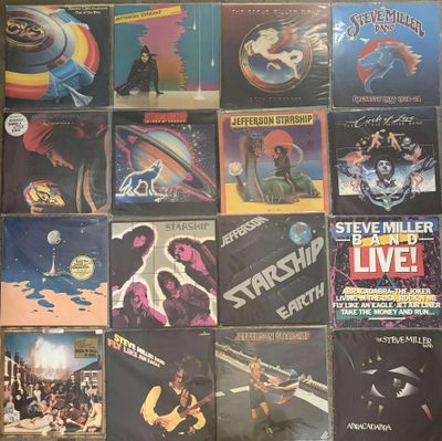 many different album covers on the wall of a room