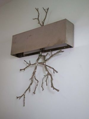 a wooden shelf with branches on it on the wall