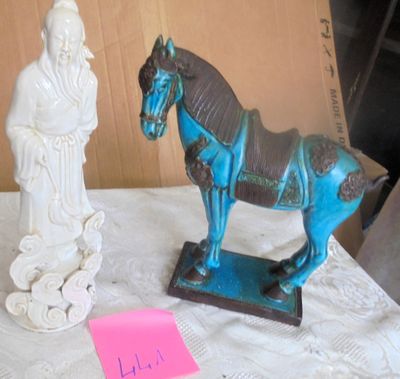 a statue of a horse and a statue of a man on a table