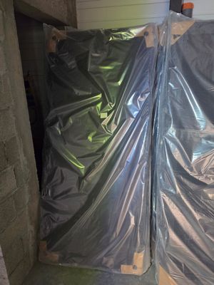 two pieces of plastic wrapped up in the corner of a room