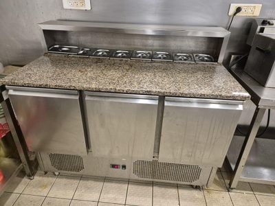 a kitchen with a stove, oven, and sink in it
