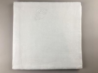 a close up of a white napkin with a monogram on it