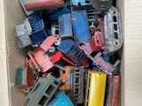 a cardboard box full of old toy cars and trucks