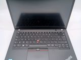 a black laptop with a red button on the keyboard