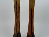 pair of brown and black vases with trees on them on a white background
